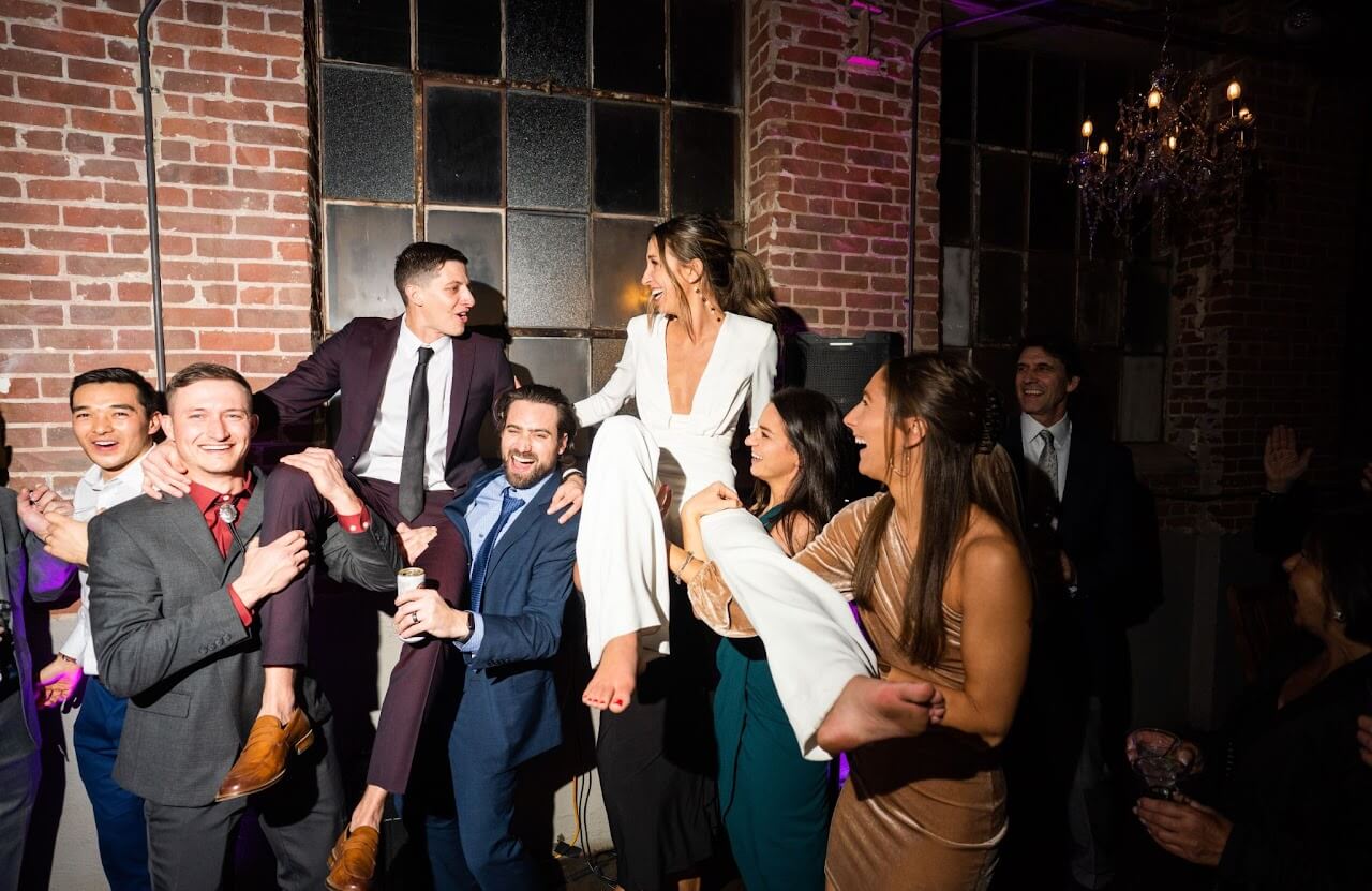 Wedding reception guests celebrating at Denver Colorado brick venue