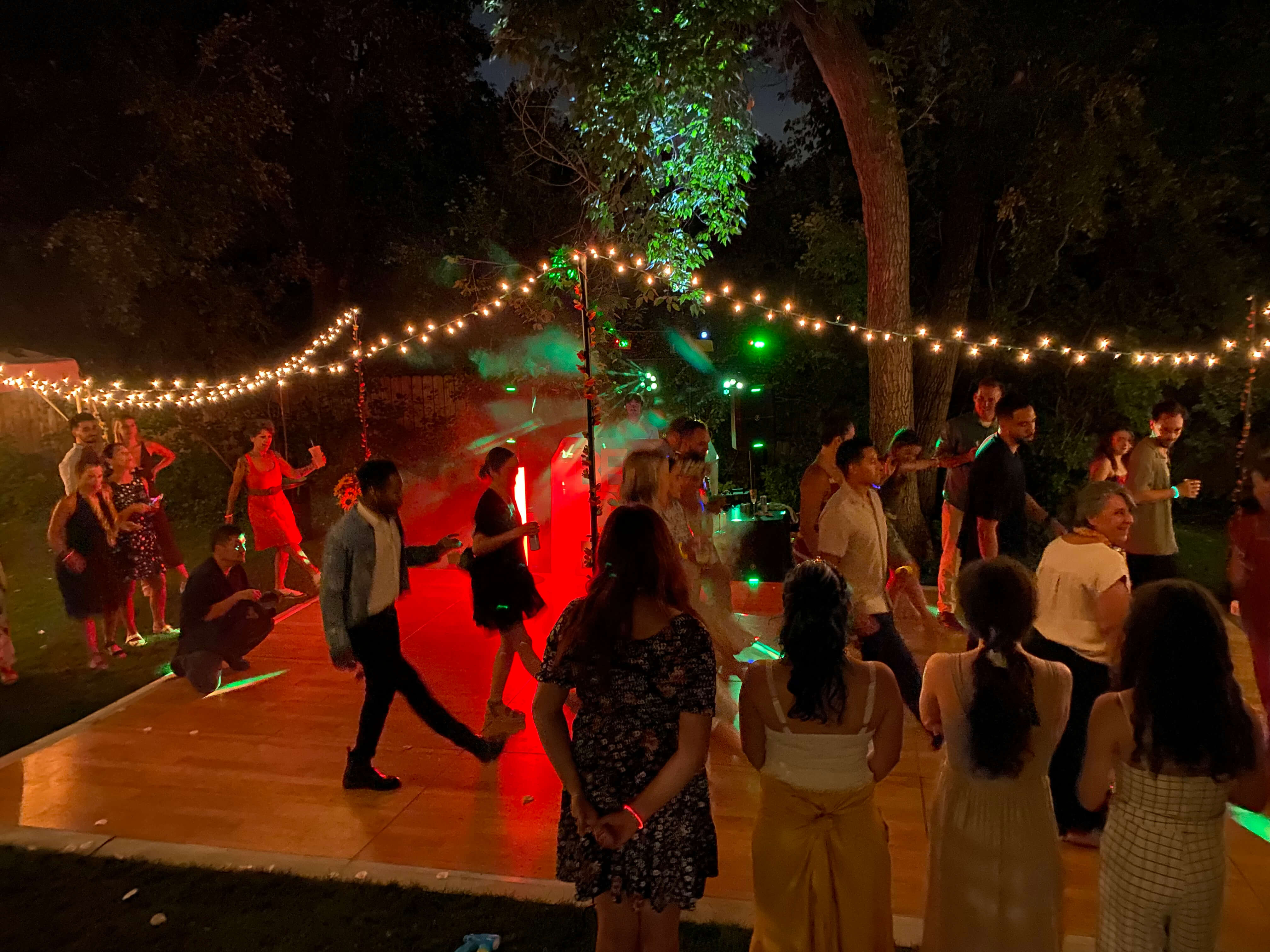 Outdoor wedding reception dance floor with string lights Colorado