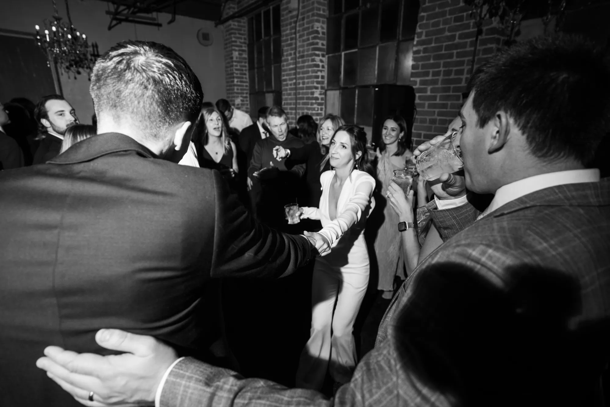 Black and white photo of the bride and groom with Josh and his speakers behind them at Moss Denver