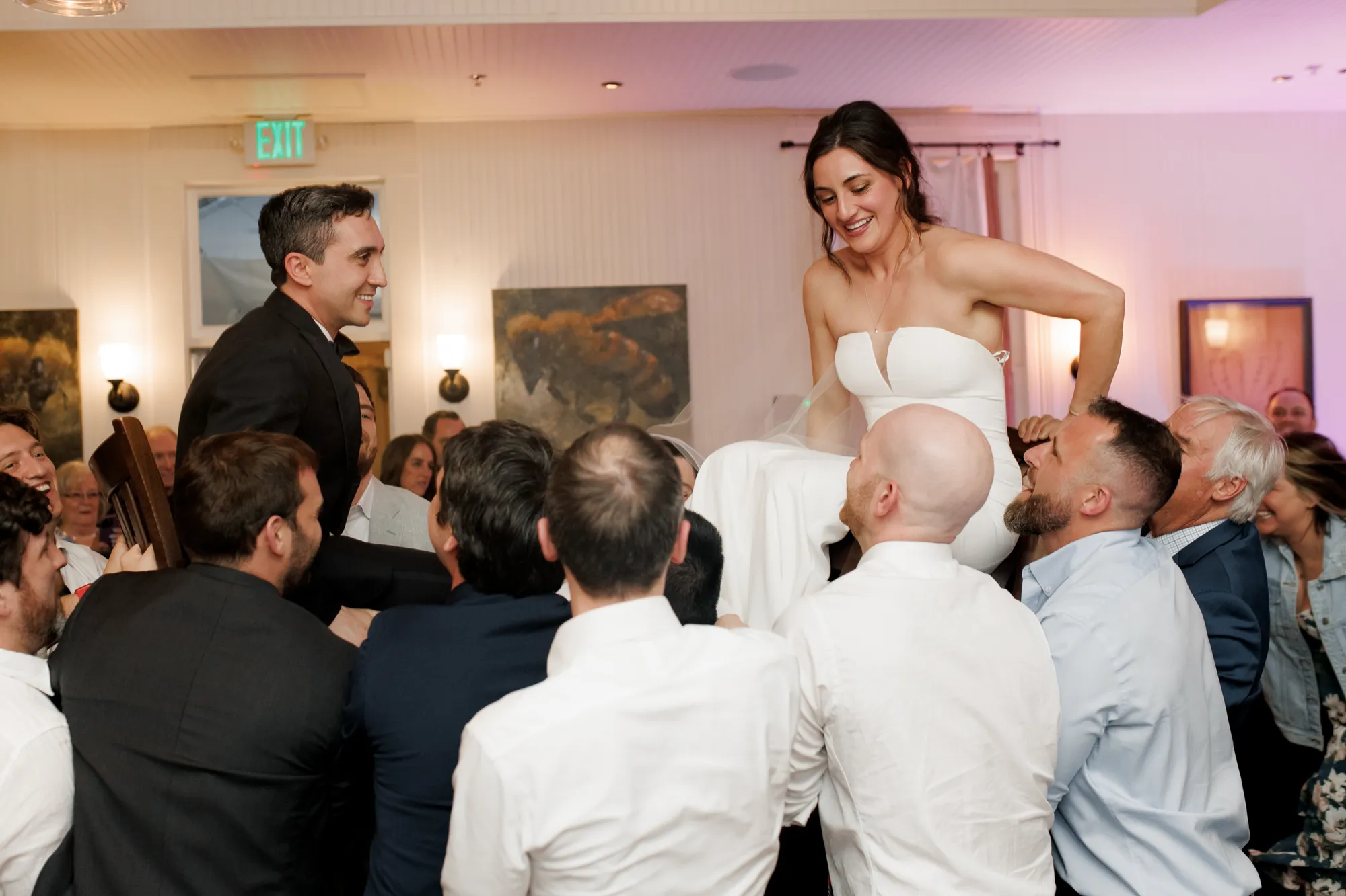 Guests lift the bride and groom on the dance floor at the Papazian wedding at Chautauqua in Boulder